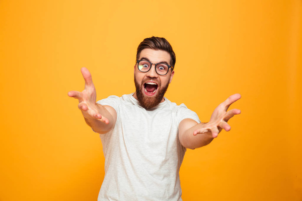 Portrait of an excited bearded man in eyeglasses - Fotó, kép