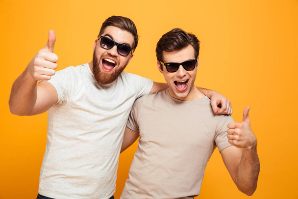 Portrait of a two cheerful young men in sunglasses - Photo, Image