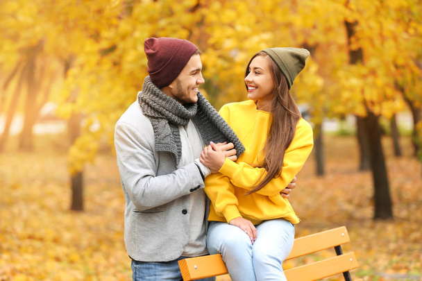Portrait of beautiful young couple on walk in autumn park - Фото, изображение