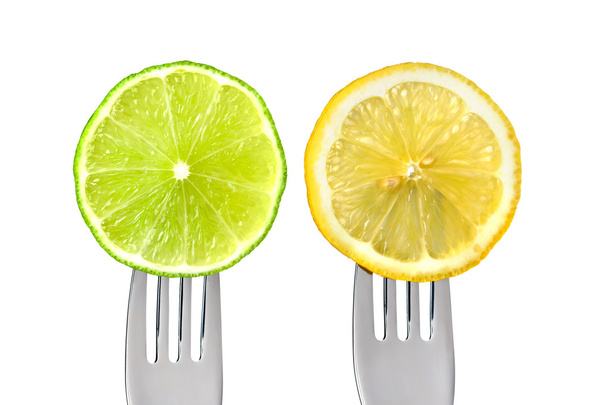 Lime and lemon on forks isolated - 写真・画像
