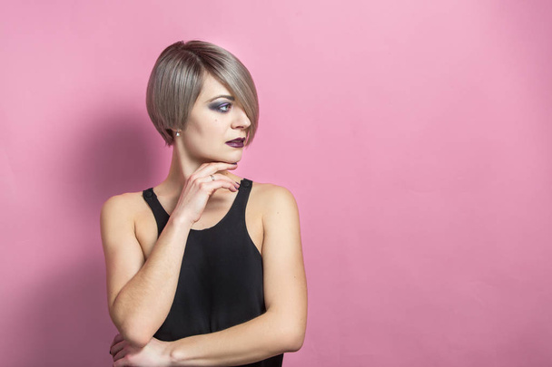 fashion beautiful young woman with short hair over pink background - Photo, Image