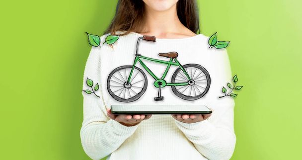 Eco Bicycle with woman holding a tablet - Zdjęcie, obraz