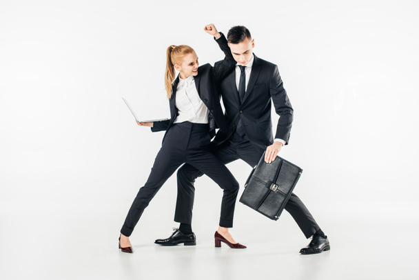 businesspeople fighting in suits with laptop and bag isolated on white - Valokuva, kuva