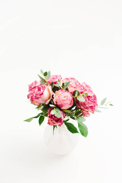 白地にピンクのバラ花束。最小限のお祝い花コンセプト. - 写真・画像