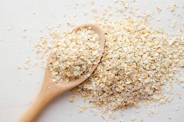 rolled oats in big spoon - Foto, Imagen