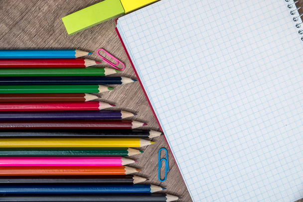 Κενό λευκό σημειωματάριο με μολύβι του χρώματος στο ξύλινο τραπέζι - Φωτογραφία, εικόνα