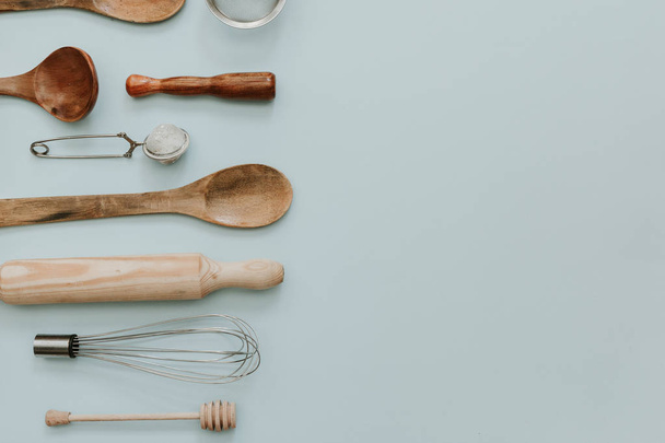 various kitchen utensils over pastel background. Flat lay minimal backing concept  - 写真・画像