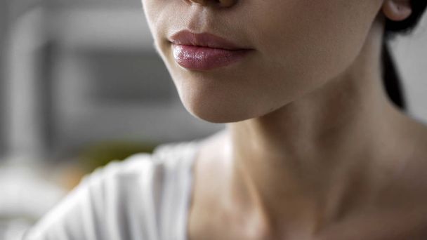Beautiful asian woman face closeup, natural skin care products, lip balm, herpes - Foto, Bild