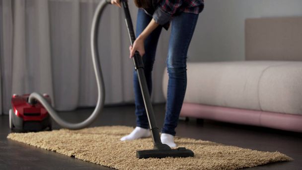 Lady carefully vacuuming bed mat, bringing house to order, allergy prevention - Fotó, kép
