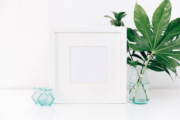 Minimalism mockup white frame with green leaves in vase .  Home decor, Styled still life - Foto, Imagen