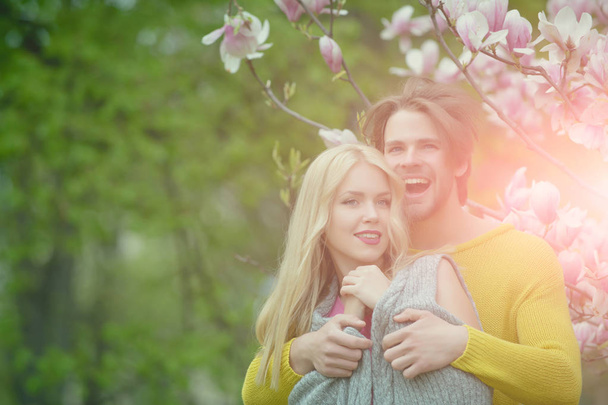man with girl or pretty woman at blossoming magnolia - Fotoğraf, Görsel