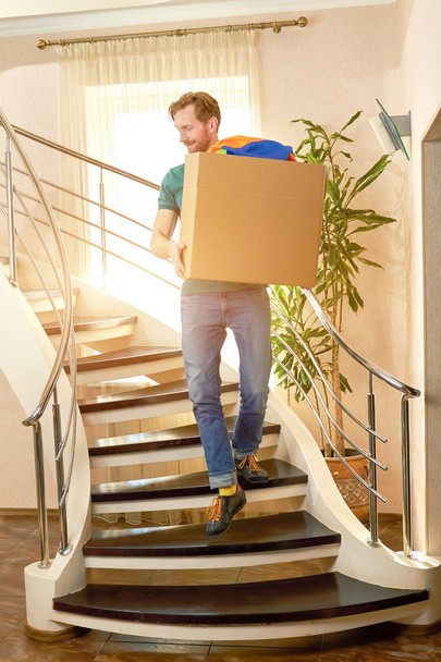 Guy carrying cardboard box. - Photo, Image