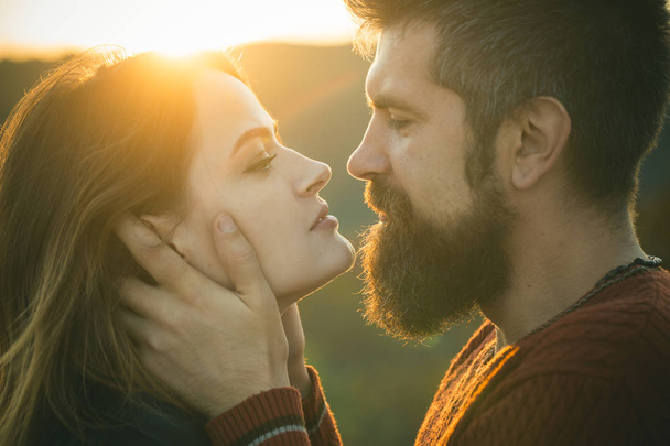Man with beard holds womans head with tenderness - Фото, зображення