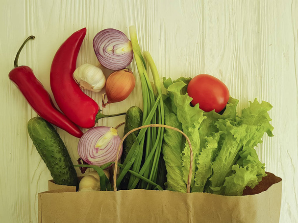organic vegetables on a white wooden paper bag - Photo, Image