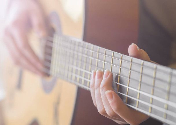 woman's hands playing acoustic guitar, close up - Fotografie, Obrázek