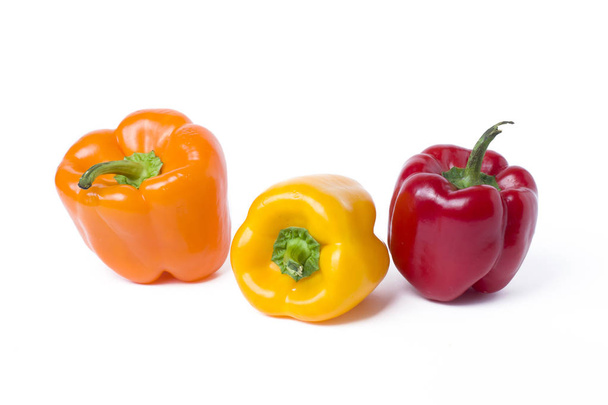 Red yellow and orange peppers on a white background - Fotó, kép