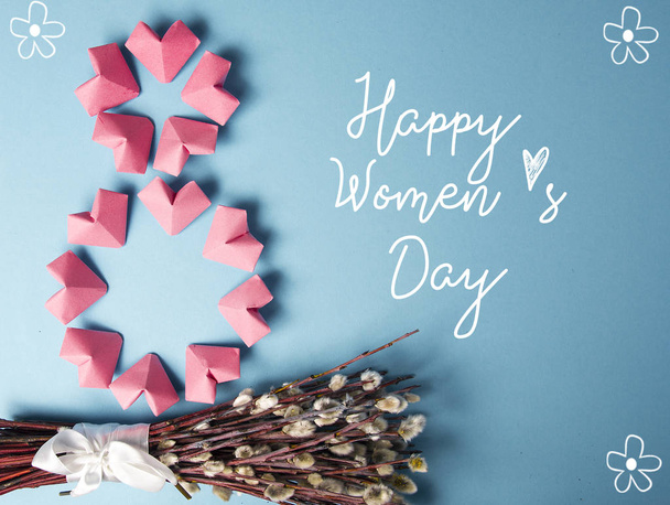 Happy International Womens Day celebrate on March 8, congratulatory CARD. rose-color paper hearts shape figure eight 8 on blue background  - Fotoğraf, Görsel