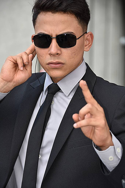 Young Security Guard Pointing Wearing Sunglasses - 写真・画像