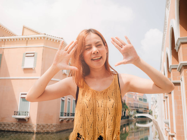 Woman tourist taking photo with funny pose on travel trip. - Photo, image
