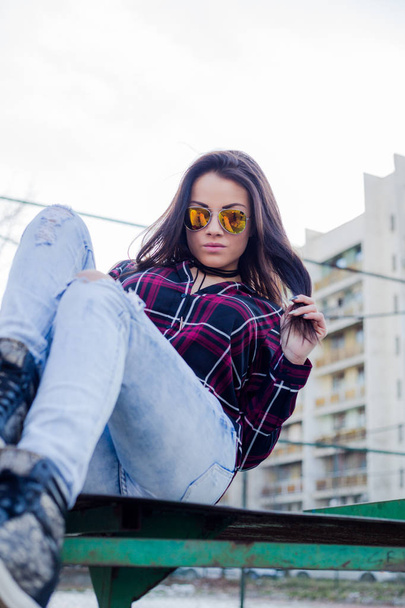 stylish young brunette woman in sunglasses posing outdoors  - Fotoğraf, Görsel