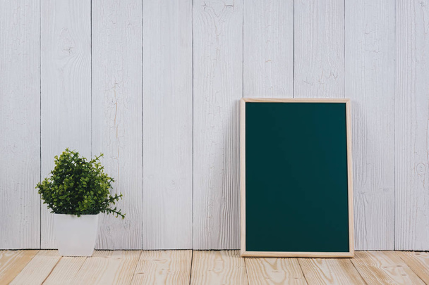 Blank green chalkborad with wood frame and little decorative tre - Fotografie, Obrázek