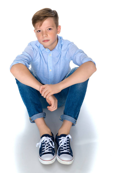 Fashionable boy teen sitting on the floor. - Fotografie, Obrázek