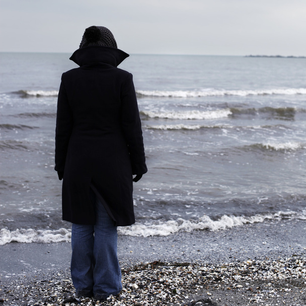 Lonely person on a beach - Fotoğraf, Görsel