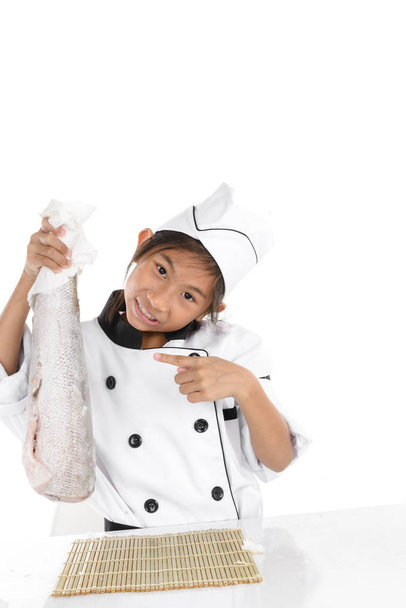 Surprising chef in uniform holding big freezing fish on white ba - Photo, Image