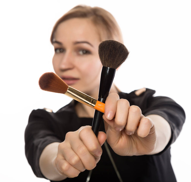 portrait of attractive smiling woman with brushes for makeup looking at camera a white background - Φωτογραφία, εικόνα