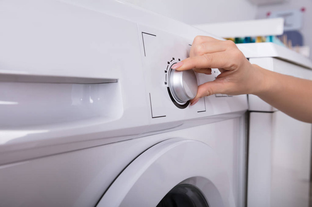 Close-up Of A Woman's Hand Turning Button Of Washing Machine - Valokuva, kuva