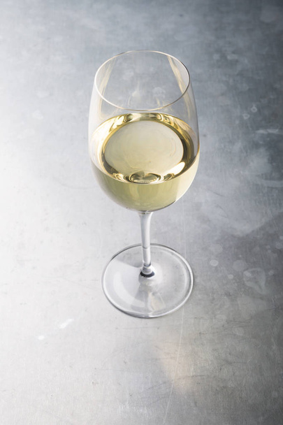 Glass of white wine on a bar counter - Фото, изображение