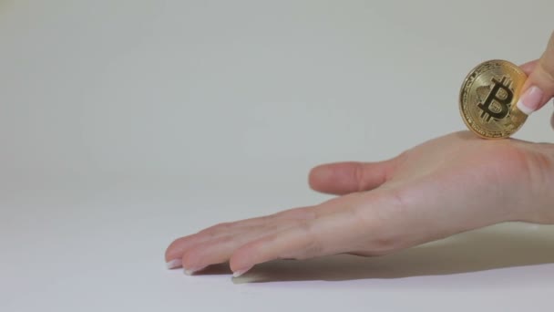 Bitcoin is rolled on a female palm, then hand showing fig - Video