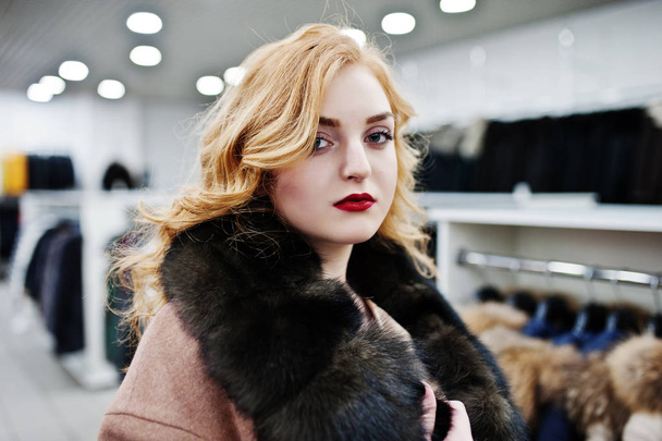 Elegance blonde girl in fur coat at the store of fur coats and l - Photo, image