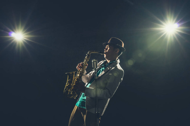 Asian Musician playing the Trumpet with spot light and lens flare on the stage, musical concept - Foto, Imagen