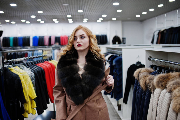 Elegance blonde girl in fur coat at the store of fur coats and l - Photo, Image