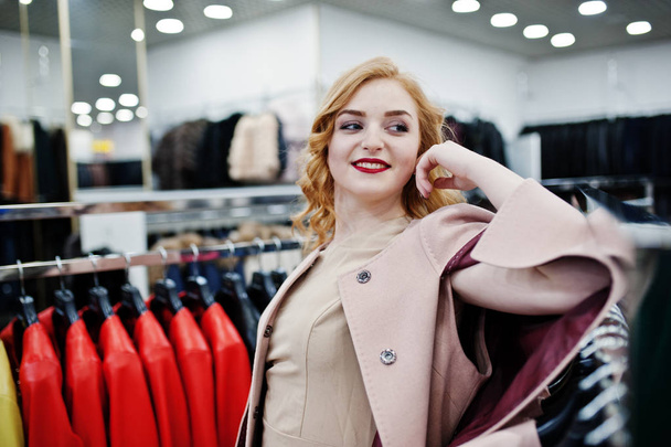 Elegance blonde girl in coat at the store of fur coats and leath - Foto, Imagem