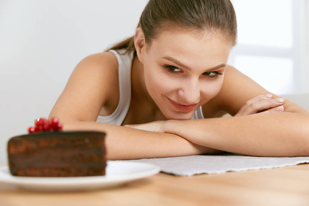 Dessert. Woman Eating Chocolate Cake - Photo, Image