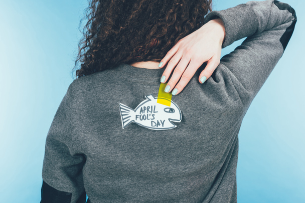back view of woman with hand drawn fish on back, april fools day concept - Photo, Image
