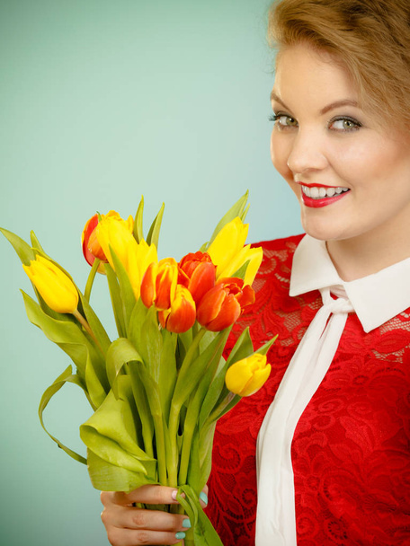 Pretty woman with red yellow tulips bunch - Фото, зображення