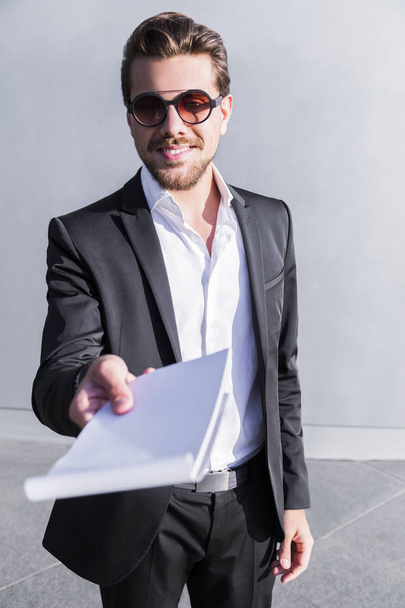 Smiling businessman or worker in suit with notebook - Fotoğraf, Görsel