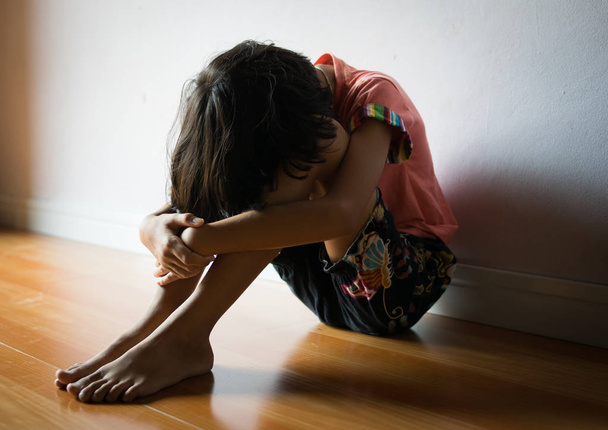 sad children,girl sitting alone in corner at home - Foto, Imagem