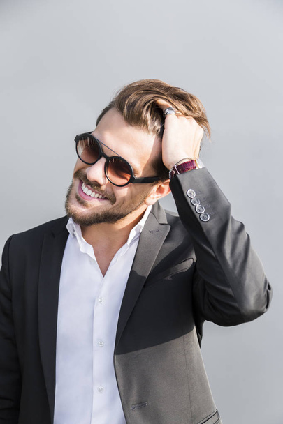 Male young businessman or worker in black suit in glasses - Foto, Bild