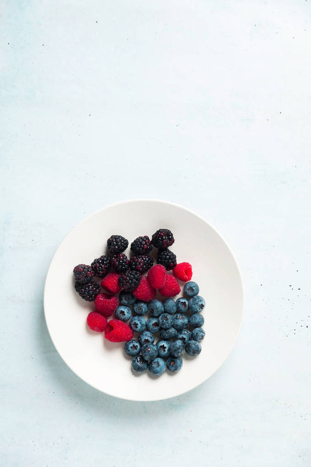Fruit salad with Various fresh summer berries in white plate . T - Photo, image