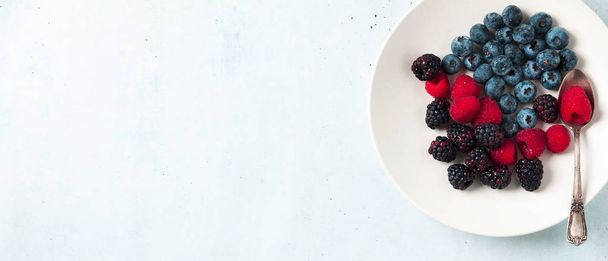 Fruit salad with Various fresh summer berries in white plate . T - Foto, afbeelding