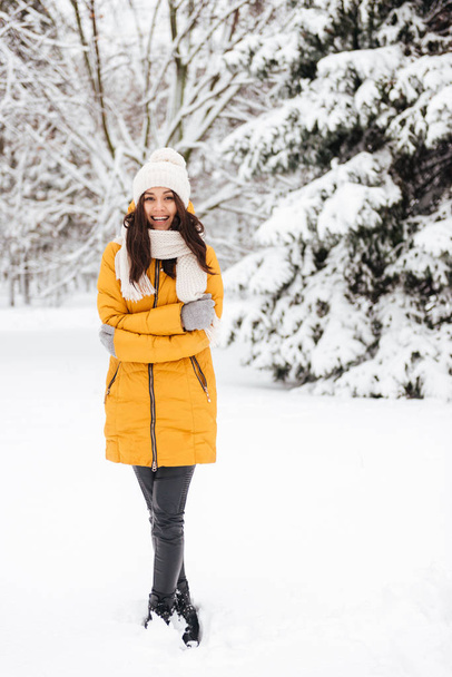 Full-length shot of young lady posing in snow park and smiling - Fotoğraf, Görsel