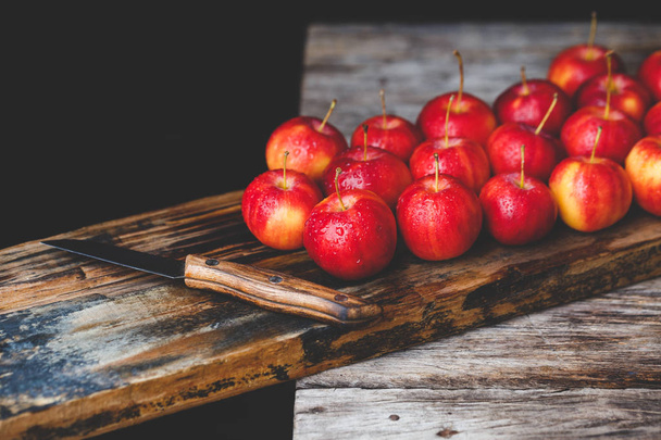 Red little apples on the old wood - Fotó, kép