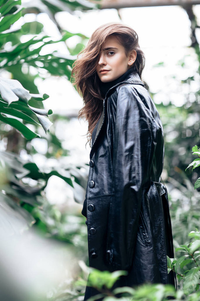 Fashion portrait of beautiful stylish woman in leather jacket on nature background - Photo, Image