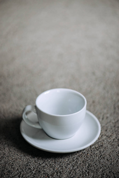 Empty white coffee cup on gray background. Copy space. - Foto, afbeelding