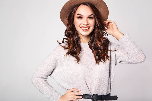 Portrait of young stylish laughing girl model in gray casual summer clothes in brown hat with natural makeup isolated on gray background. Looking at camera - Foto, imagen