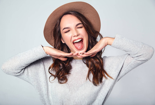 Portrait of young stylish laughing girl model in gray casual summer clothes in brown hat with natural makeup isolated on gray background. Looking at camera - Fotoğraf, Görsel